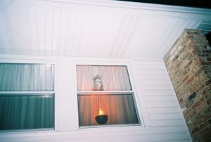 A torch and severed head in the window