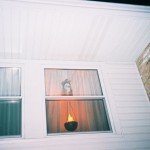 A torch and severed head in the window